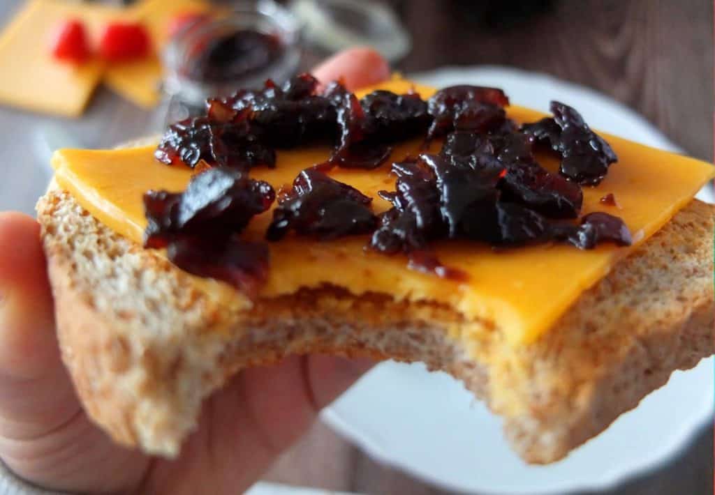 Red onion chutney on a slice of red cheddar 