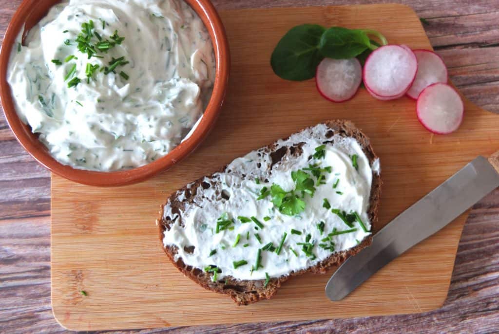 Quark Dip on a chopping board with rye bread 