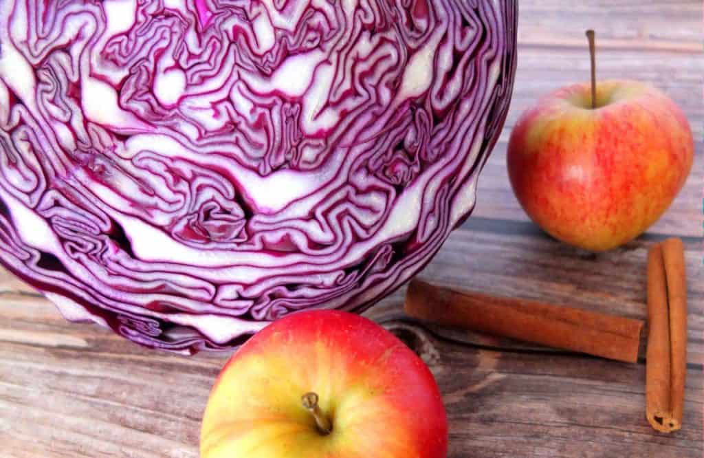 a red cabbage with cinnamon sticks and apples
