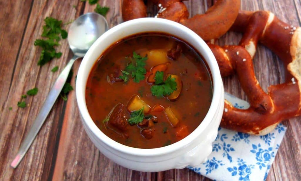 German Goulash Soup with 2 pretzels in the background