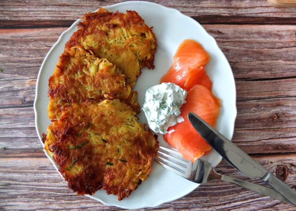 A plate with Kartoffelpuffer and quark dip and smoked salmon