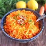 German Apple Carrot Salad with lemons and carrots in the background