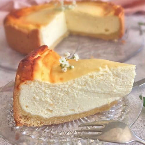 A slice of German cheesecake on a plate