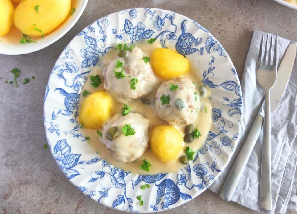 German Meatballs in caper sauce with cutlery