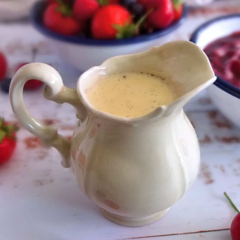 German Vanilla Sauce in a Saucier. In the Background there is a bowl of fruits
