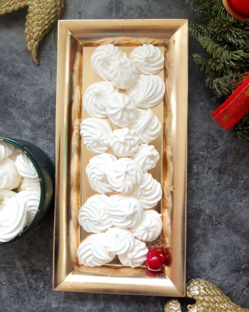 German Baiser Cookies on a golden rectangular plate.