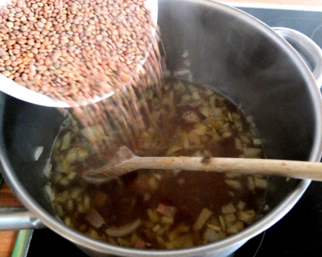 adding the lentils to the broth