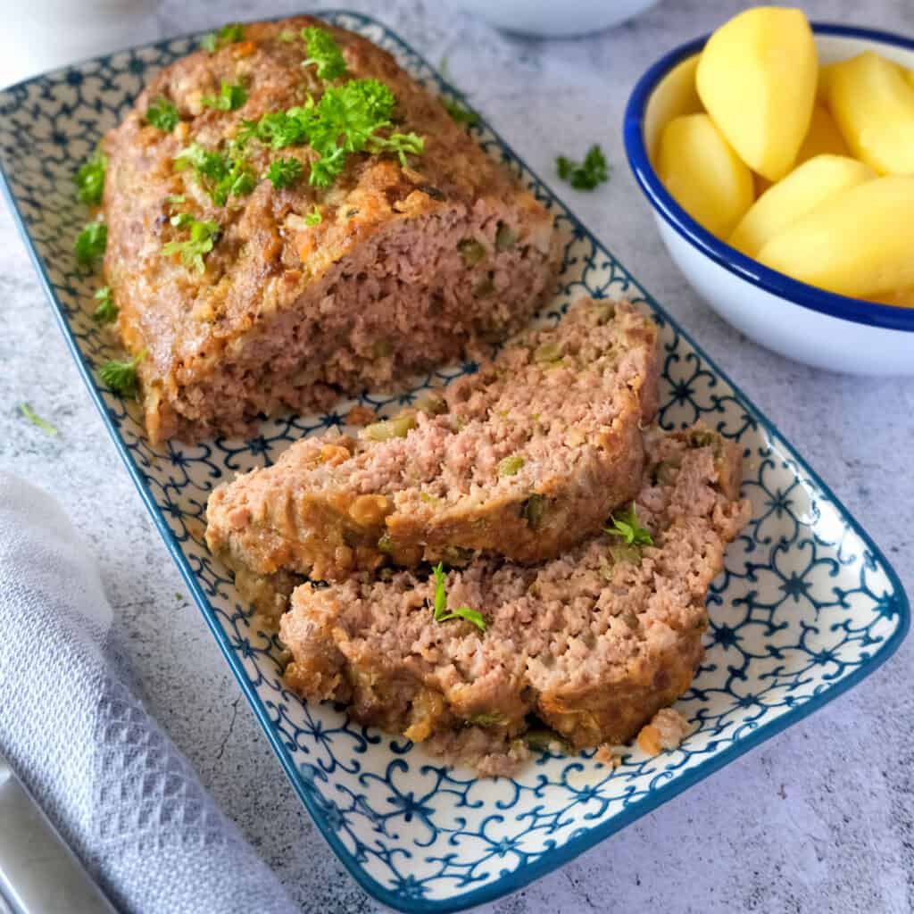 German Meatloaf on blue and white plate.