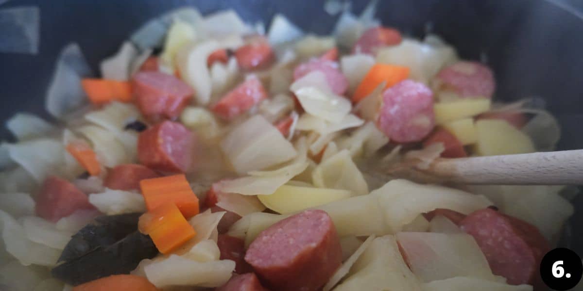 adding sausages to soup.