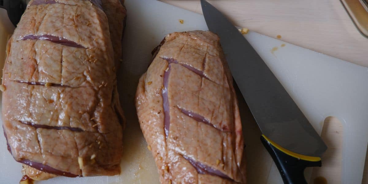 cutting the skin of the duck breast
