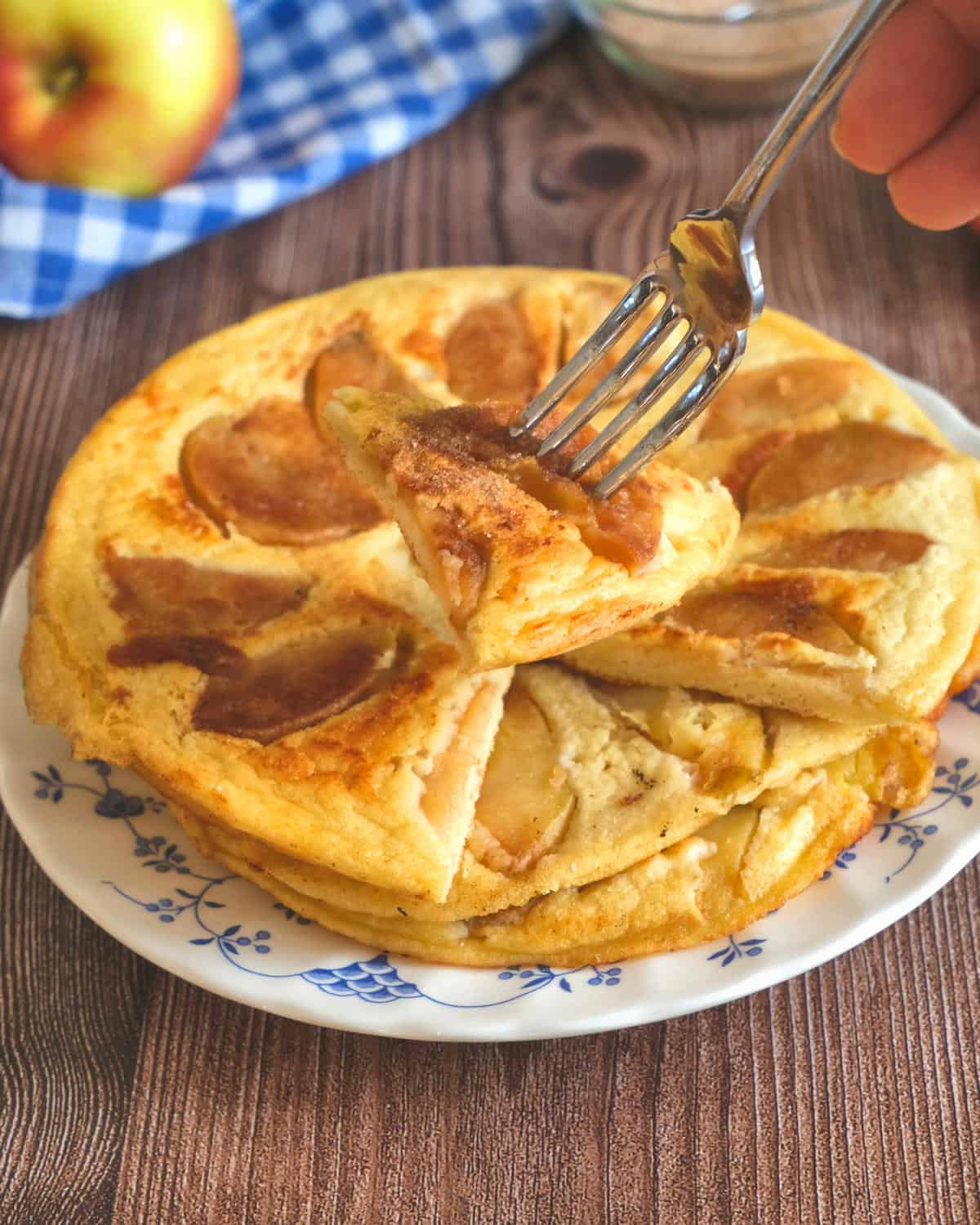 a slice of German apple pancake on a fork.