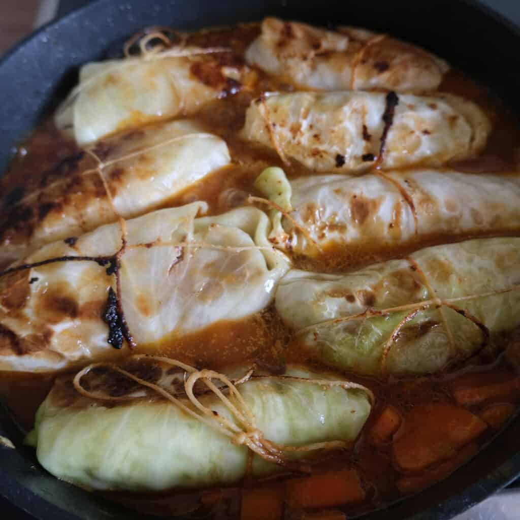 German cabbage rolls simmering in broth.