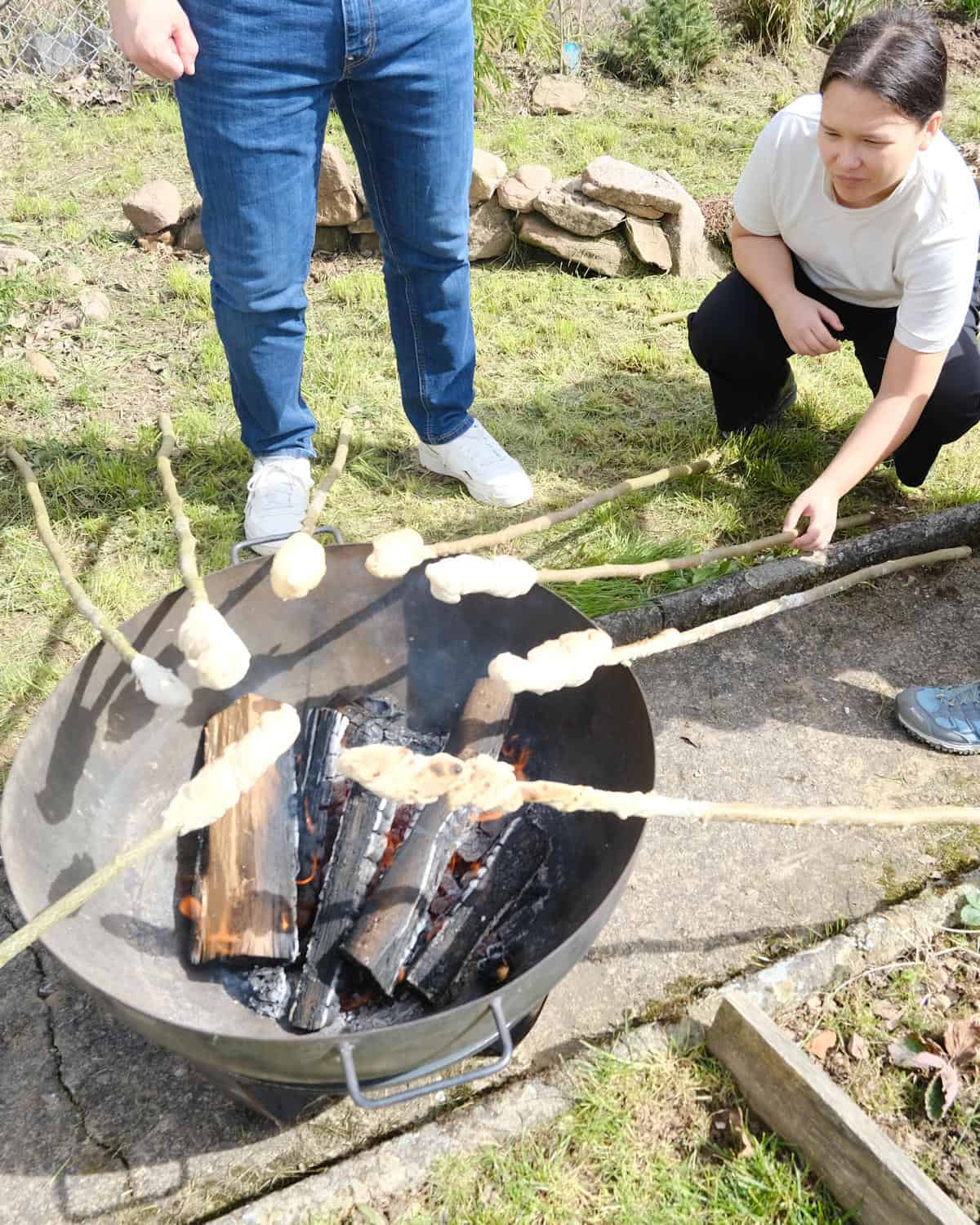 cooking the bread on a stick