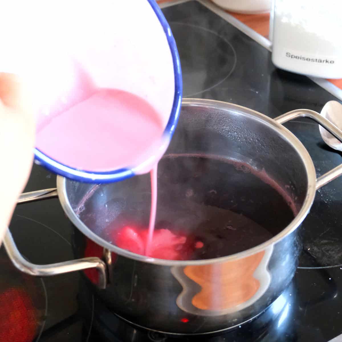 pouring corn starch into cherry juice