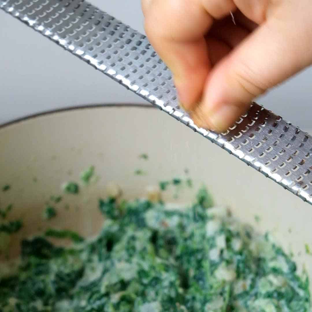 seasoning creamed spinach with nutmeg.
