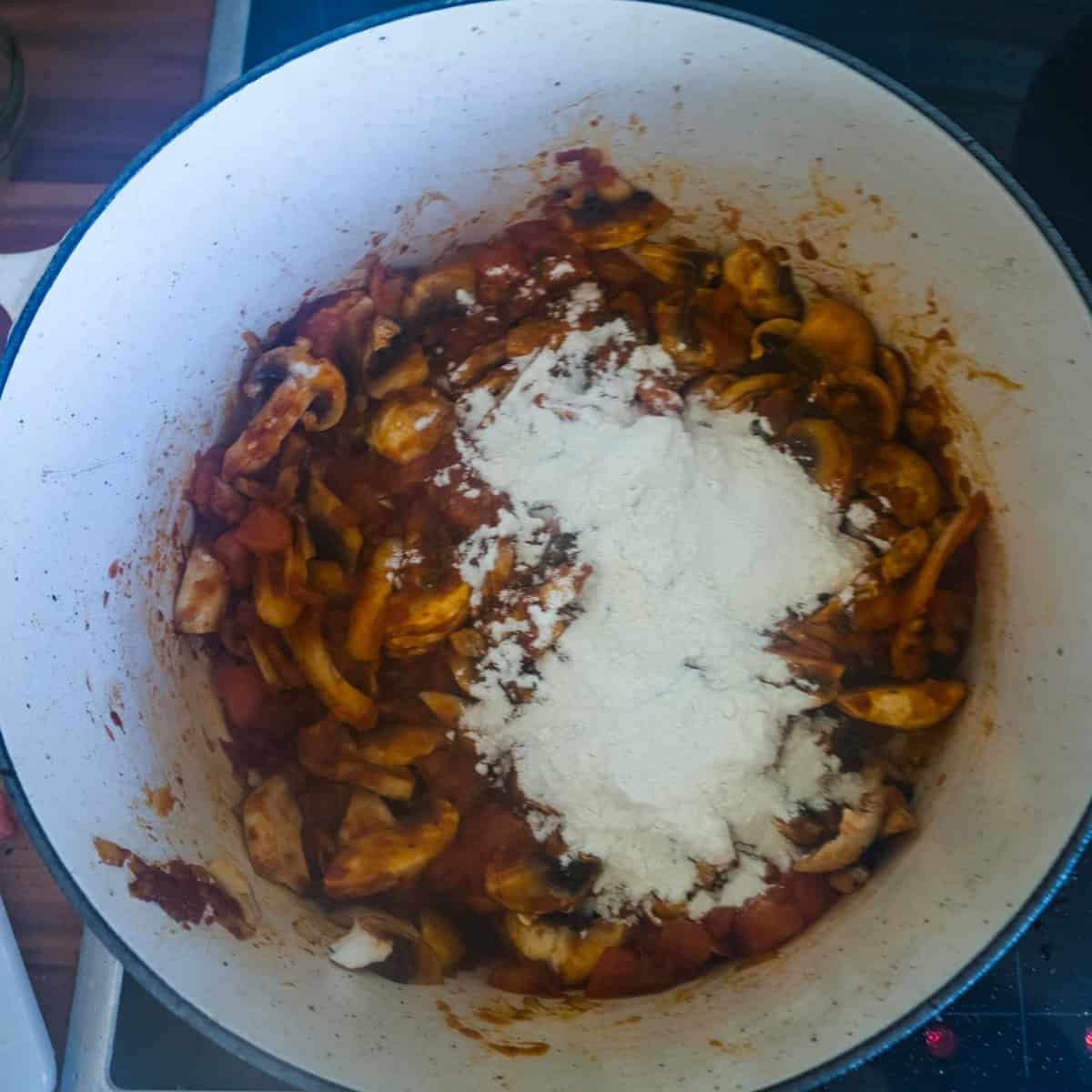 dusting the mushrooms and tomatoes with flour