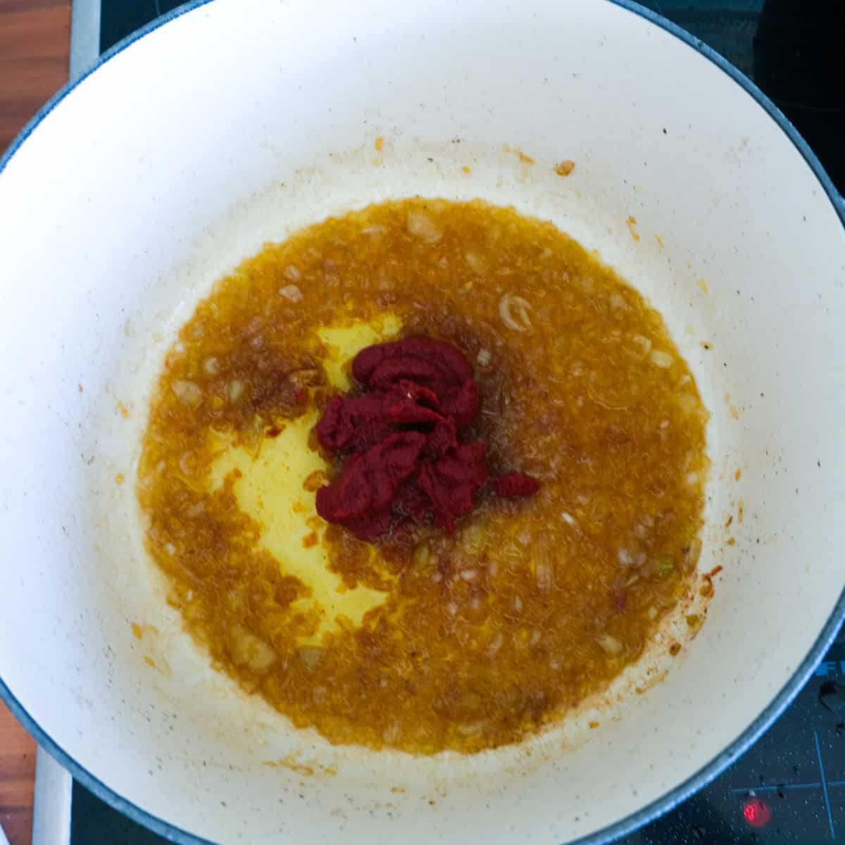 adding the tomato puree to the onions