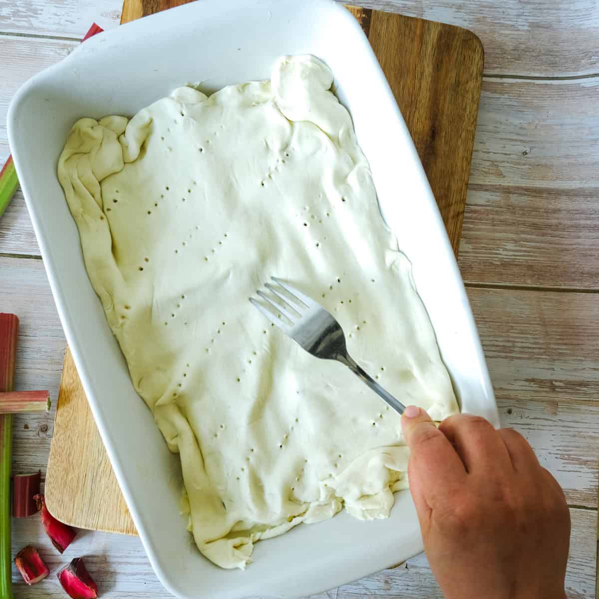 pricking the puff pastry for rhubarb tart