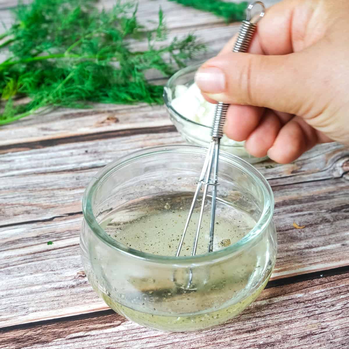 making the german cucumber salad dressing with oil, vinegar and sugar