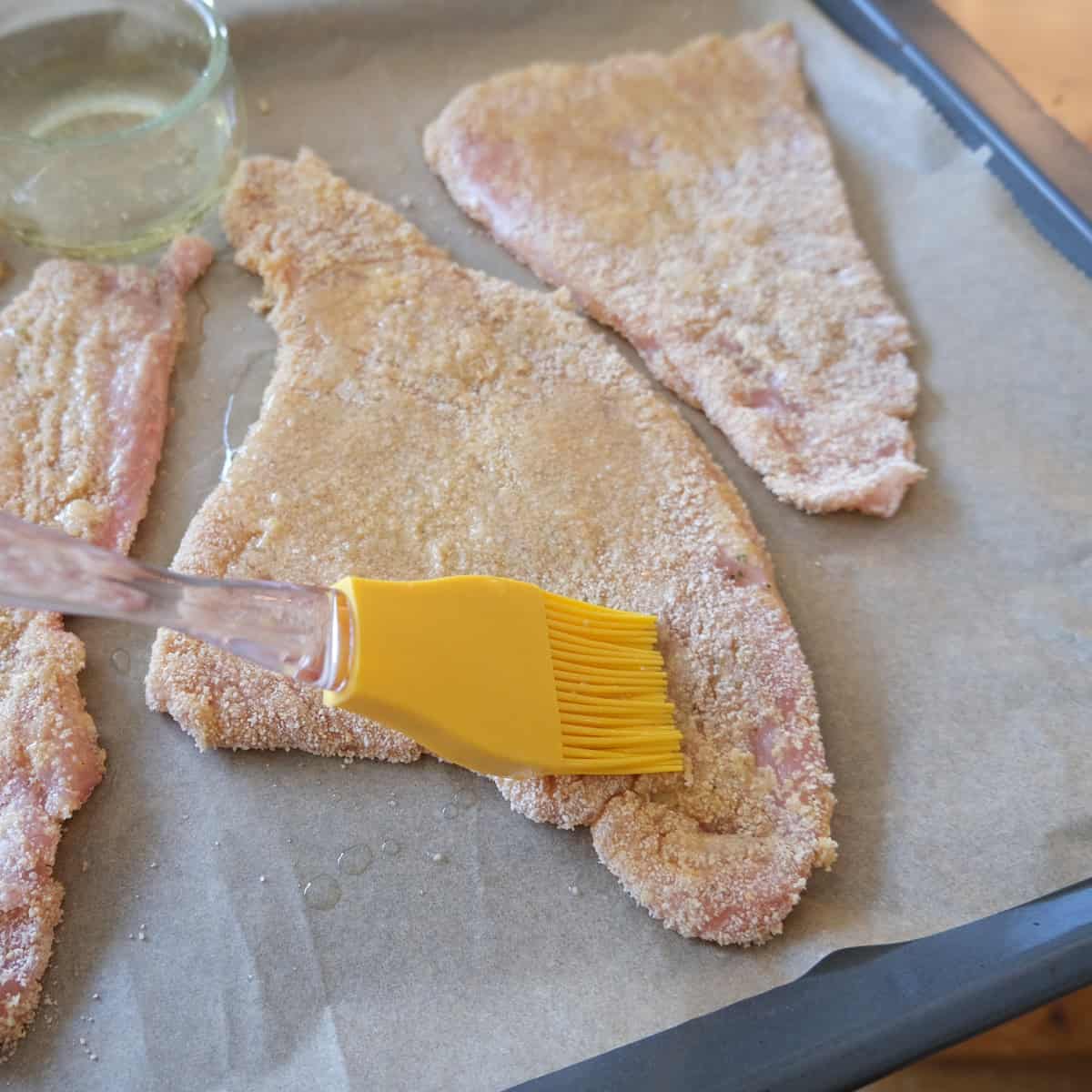 coating the schnitzel in oil to be backed