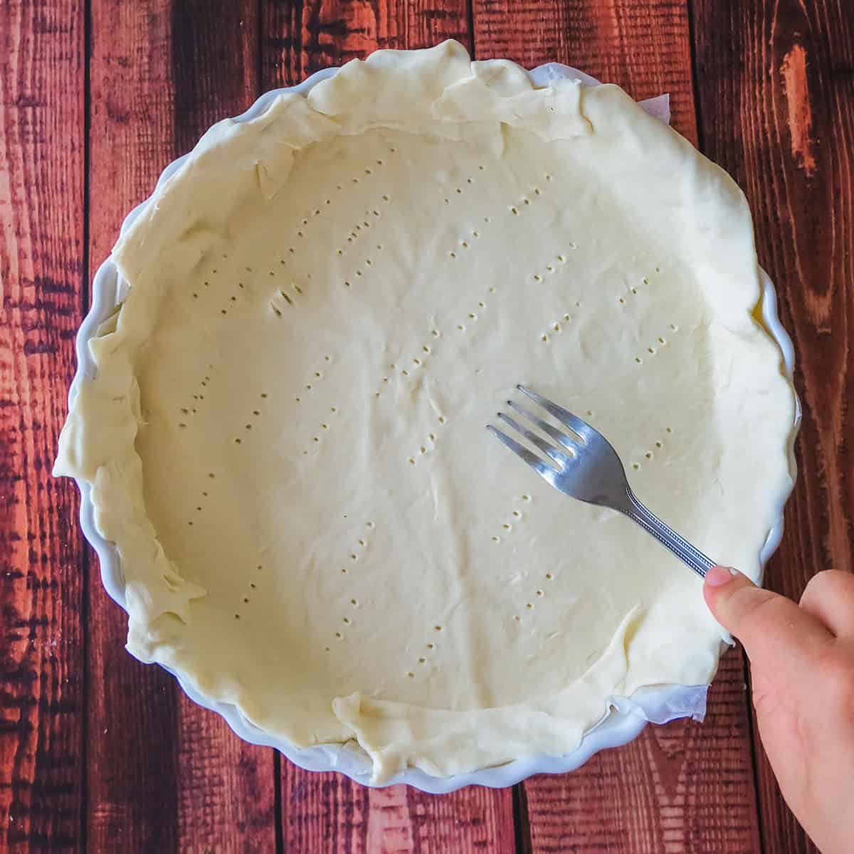 Place the puff pastry into your quiche dish and prick with a fork to allow it to cook evenly
