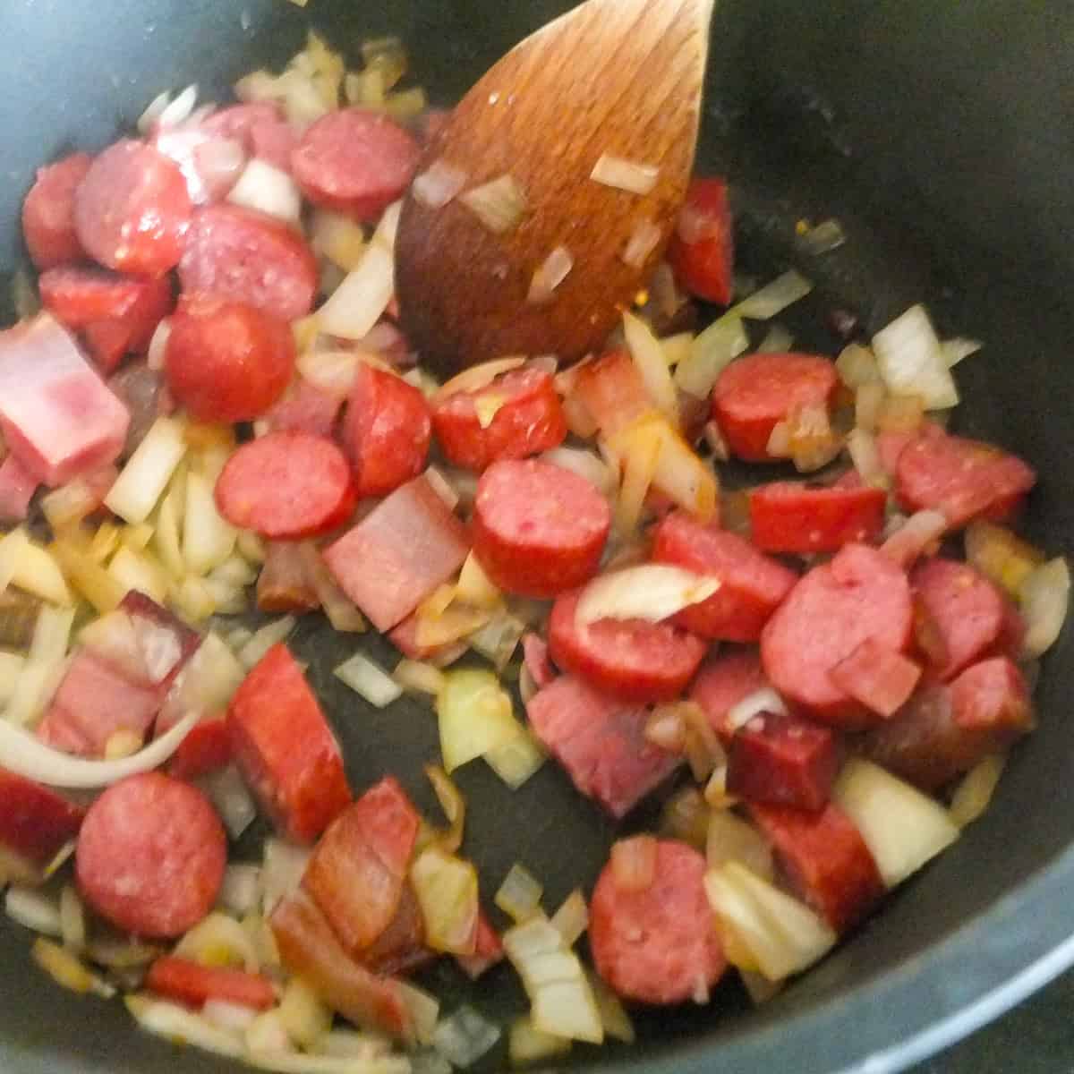 frying bacon, sausages and onions