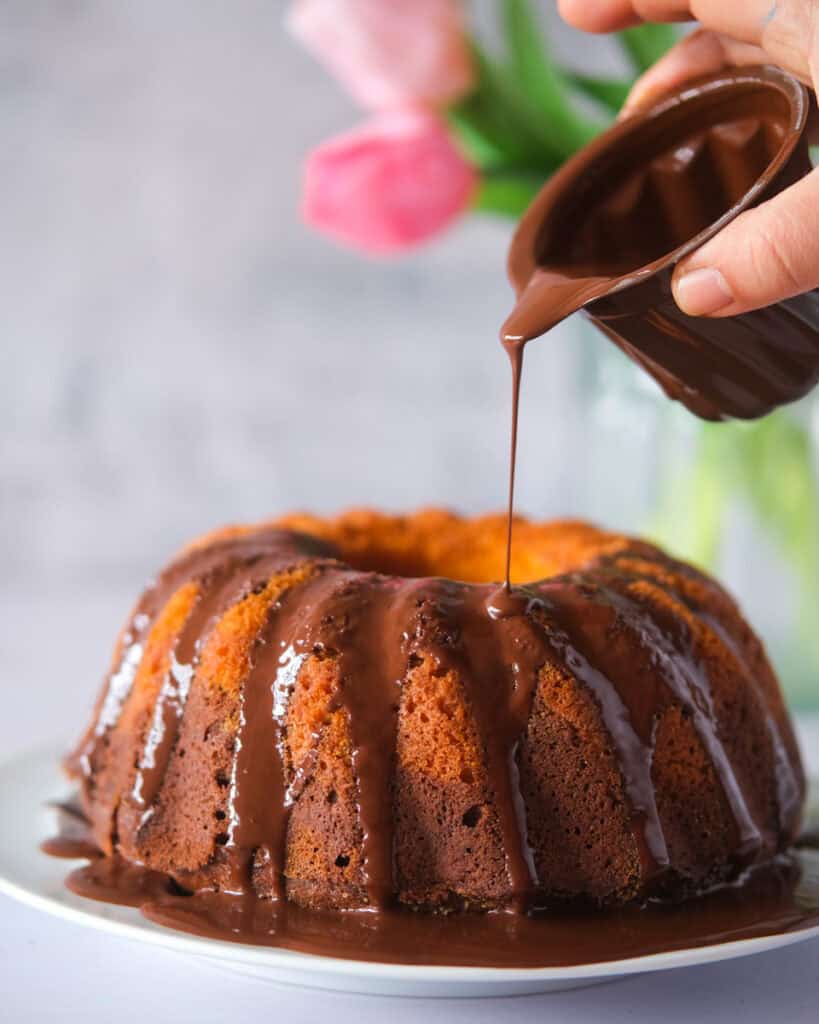 Drizzing chocolate over German Marble Cake