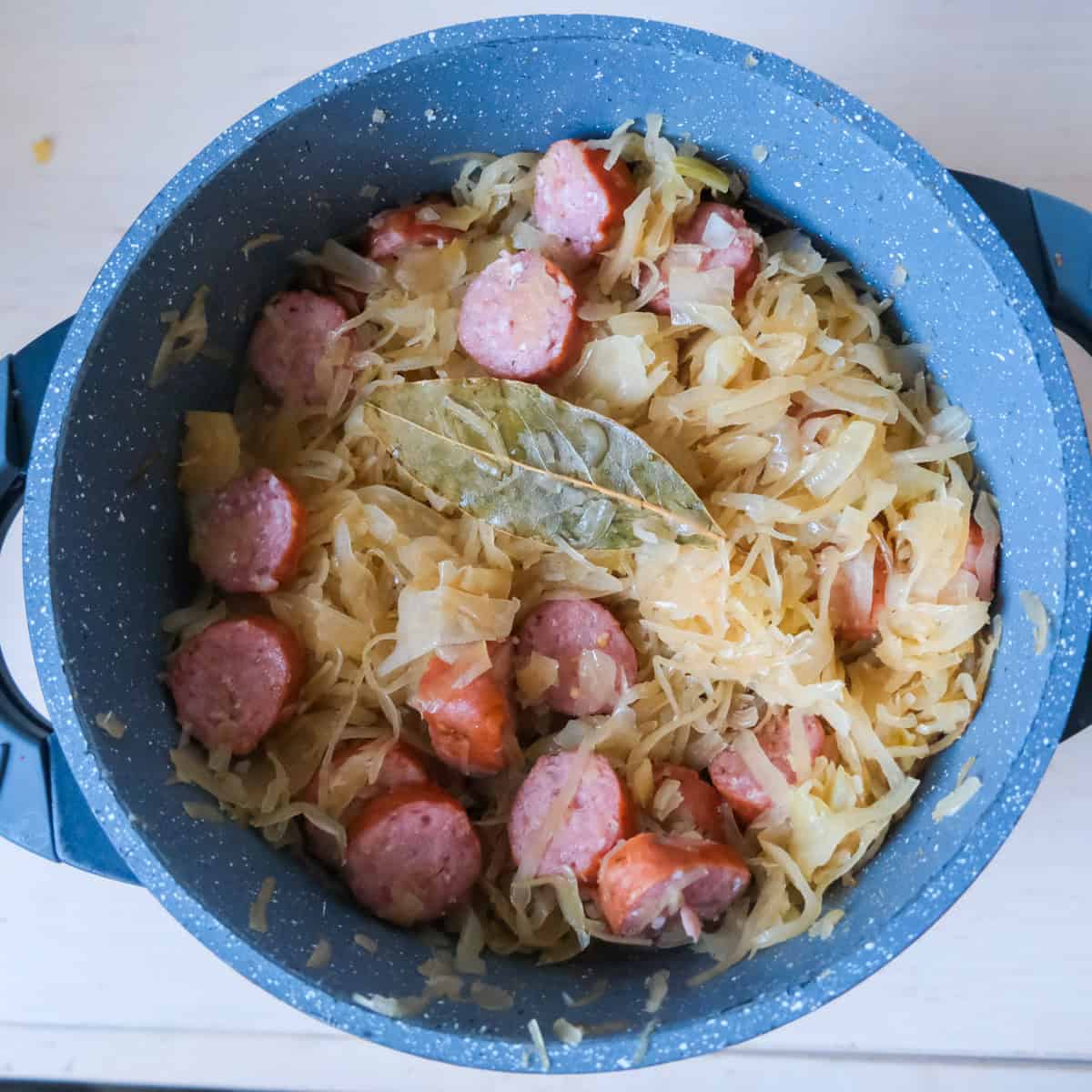a pot with sauerkraut and sausages