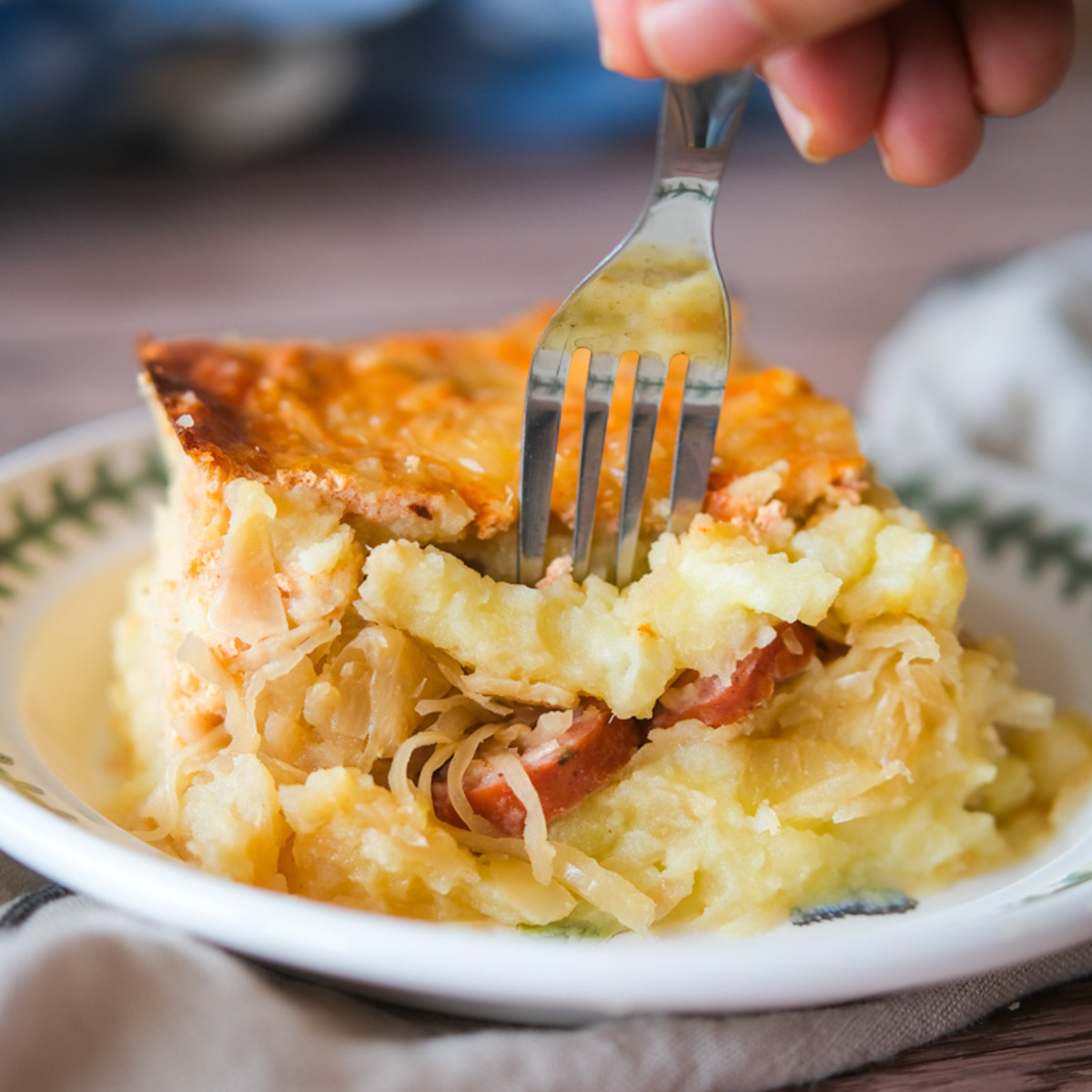 a fork chugging into a german sauerkraut casserole