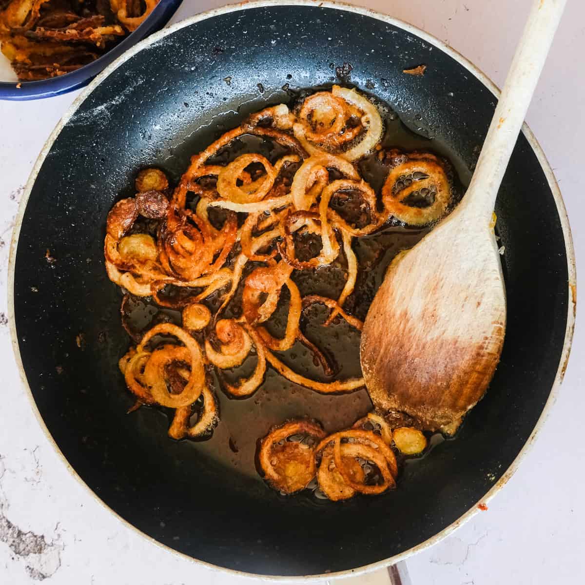 crispy fried onions in a saucepan.