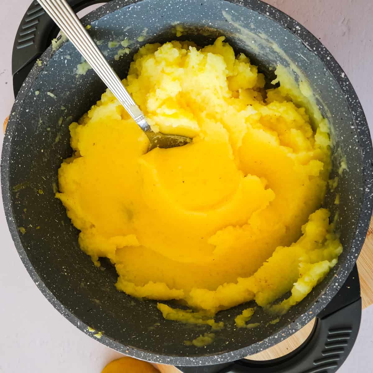 mash potatoes in a pot.