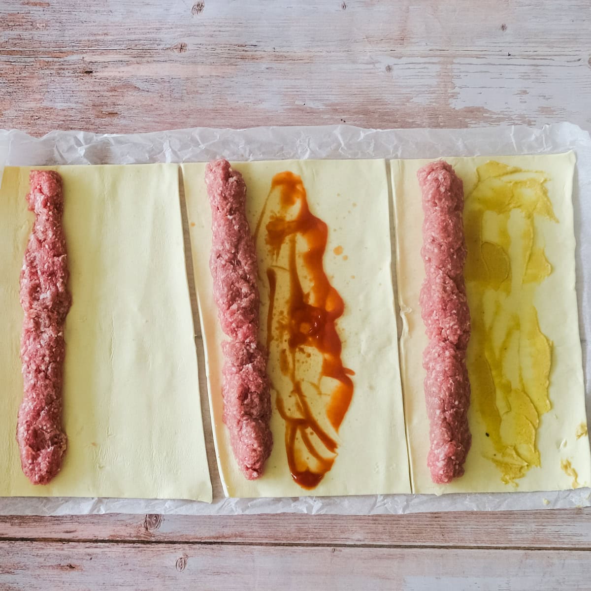 adding sausage meet to puff pastry.